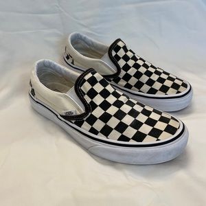 Classic black and cream checkered slip on Vans.